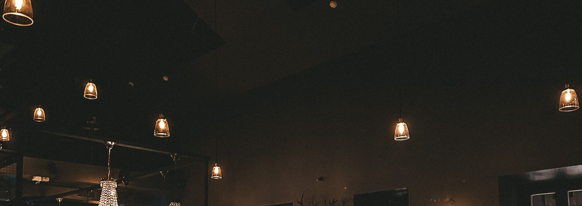 Dark elegant restaurant with crystal chandeliers